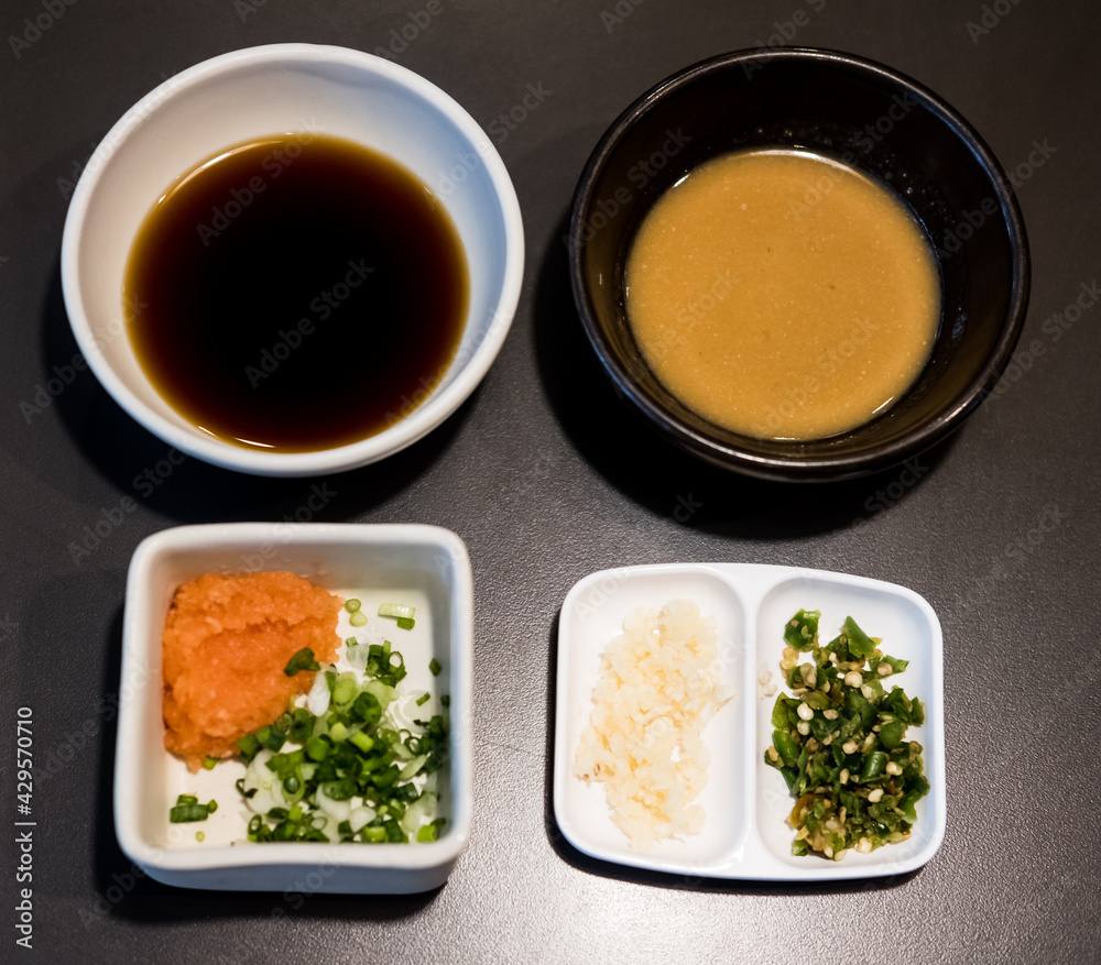 Wall mural dipping ponzu sauce with garlic, chili pepper and green onion and white sesame sauce