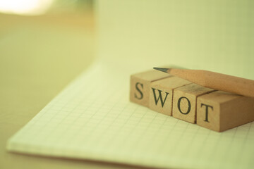 Swot word written on wood cube. Strengths, weaknesses, threats and opportunities of company