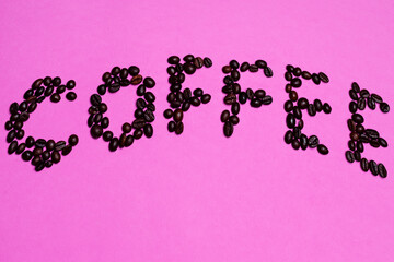 Food and Beverages Concepts. Word Made Of Variety of Freshly Roasted Coffee Beans Placed on Pink Background By Bended Curve Line.
