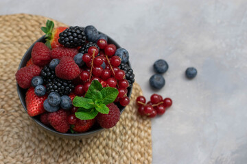 Ripe sweet different berries in bowl. Close up, top view. rvest Concept