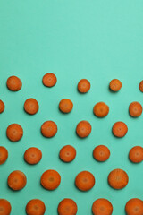 Slices of fresh carrot on mint background