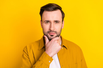 Photo of young handsome man hand touch chin enjoy skincare barbershop isolated over yellow color background