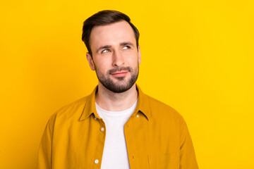 Photo of young handsome man happy positive smile dream think look empty space isolated over yellow color background