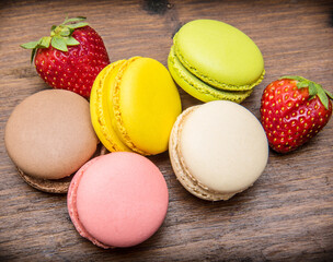  Sweet colorful macaroons. Delicious macarons on wooden table as background