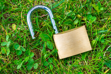 Open padlock, placed on the ground. Reopening, restart, freedom. 
