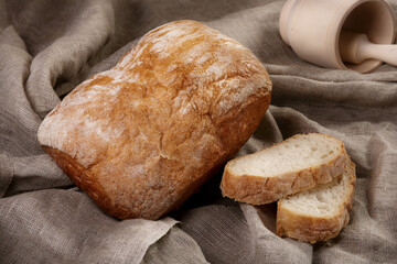 Bread and sliced pieces on flax