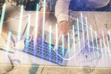 Multi exposure of man and woman working together and forex graph hologram drawing. Financial analysis concept. Computer background. Top View.