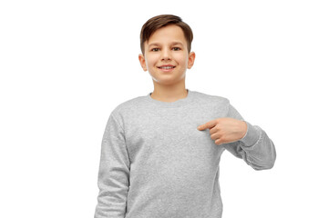 childhood, fashion and people concept - happy smiling boy pointing fingers at himself over white background