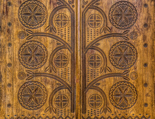 Poltava, Ukraine - April 14, 2021: beautiful wooden door with a carved floral pattern in the Ukrainianhistorical building in the Ukrainian Art Nouveau style. Museum of Local Lore in Poltava, Ukraine