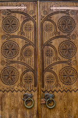 Poltava, Ukraine - April 14, 2021: beautiful wooden door with a carved floral pattern in the Ukrainianhistorical building in the Ukrainian Art Nouveau style. Museum of Local Lore in Poltava, Ukraine