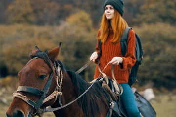 Foto op Canvas woman hiker riding a horse in the mountains walk fresh air travel © SHOTPRIME STUDIO