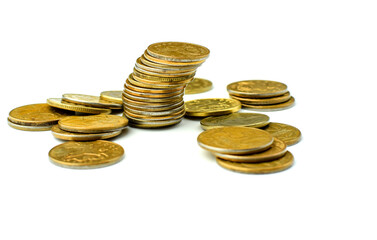 Money coins in a stack tilted to the side isolated on a white background. Stacks of coins fall. Metal money is scattered around. The fall in the exchange rate. Selective focus. Copy space.