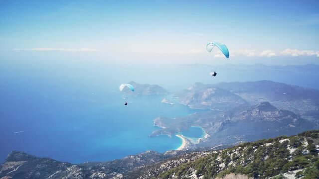 Amazing high angle top drone view on world famous paragliding and parasailing turkish spot for extrim parachute sport in Oludeniz in Fethiye, Turkey