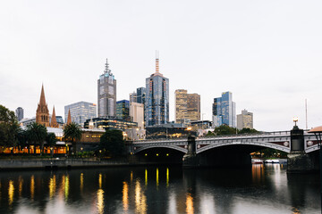 Fototapeta na wymiar Princes Bridge and city buildings on the Yarra River in Melbourne, Australia in the evening - 2021