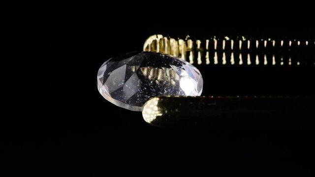 natural morganite gemstone in tweezer on the turn table
