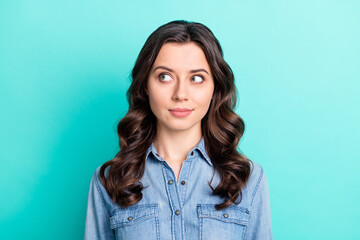 Fototapeta premium Photo of adorable sweet young lady dressed denim shirt smiling looking empty space isolated teal color background