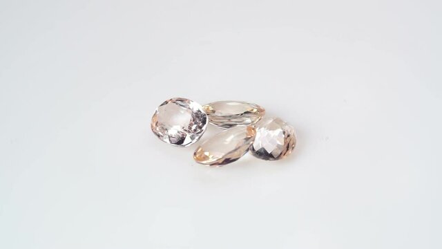 natural morganite gemstone on the white background on the turning table