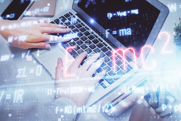 Double exposure of woman hands typing on computer and formula hologram drawing. Education concept.