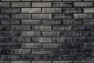 Old black and brown brick wall texture background. Free space for text or design.
