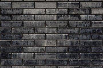Obraz premium Old black and brown brick wall texture background. Free space for text or design.