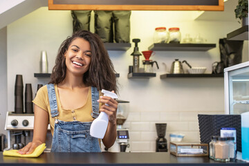 Happy woman with napkin and sanitizer at bar