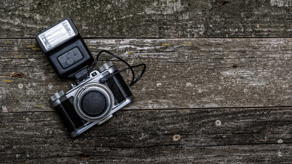 Old camera on wooden black background