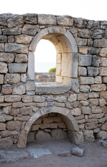The window is made of masonry of ancient stones .