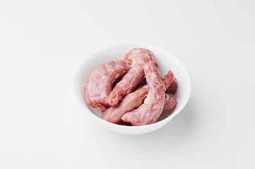 raw chicken necks on a white plate isolated on a white background. Mockup