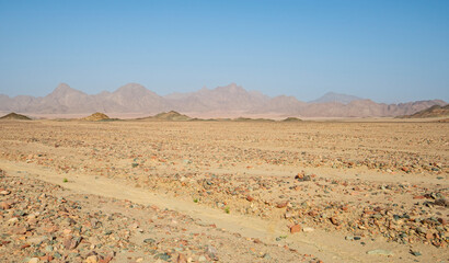 Fototapeta na wymiar Barren rocky desert landscape in hot climate