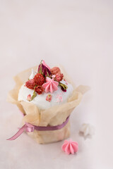 Easter cake on a pink background decorated with dried flowers