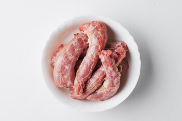 raw chicken necks on a white plate isolated on a white background. Mockup