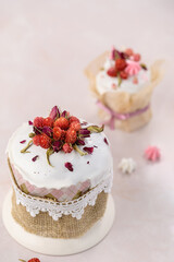 two Easter cakes on a pink background decorated with dried flowers