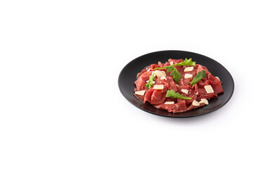 Marbled beef carpaccio on black plate isolated on white background. Copy space