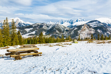 Mountain glade in winter scenery.    Picnic tables with banches   inn white winter  landscape of  Hight Tatra Mountains. Hiking trail to Rusinowa glade, Tatra Mountain , Poland   © krysek