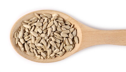 Peeled sunflower seeds in wooden spoon isolated on white background, top view