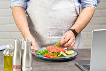Cooking with notebook tuna steak in home kitchen. Online receipt concept