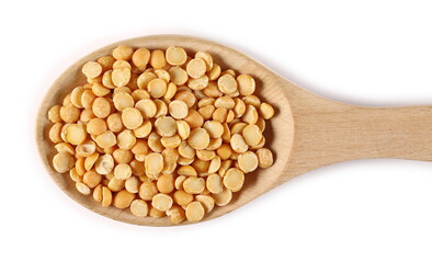 Yellow split peas in wooden spoon isolated on white background, top view