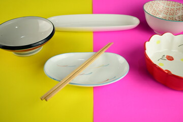 cute ceramic bowl plate on bright pink and yellow background