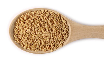 Soy flakes pile in wooden spoon isolated on white background, top view