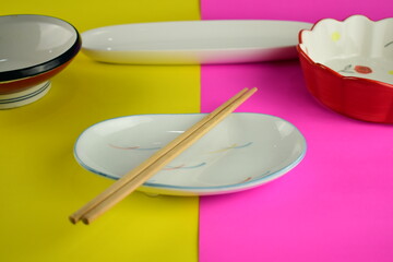 cute ceramic bowl plate on bright pink and yellow background