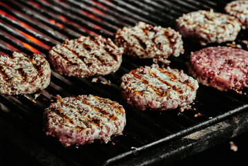 burger cutlets on a grill - cutlets made from organic beef. raw cutlets