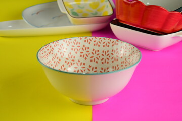 red and white abstract pattern ceramic bowl with messing stacking bowl on beautiful bright pink and...