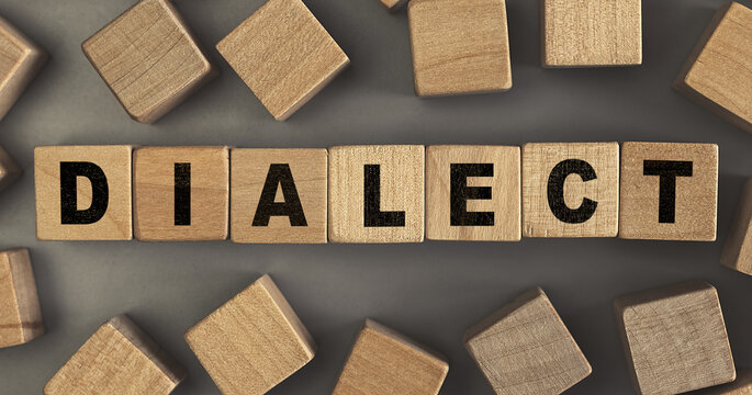 The word DIALECT on small wooden blocks at the desk. Top view