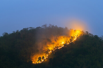 Wildfires on the mountain tops in the evening after sunset began to see more clearly the orange...