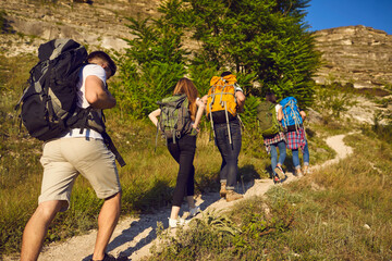 Group friends traveling and hiking in the summer mountain take the adventure