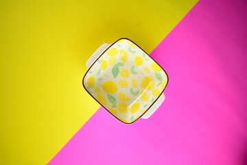 yellow lemon ceramic bowl on bright beautiful background topview