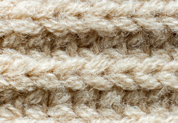 The background is made of natural beige fabric. knitting pigtail. Suitable for your text or logo. Top view. Copy space.