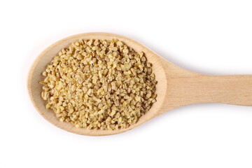 Dried bulgur pile in wooden spoon isolated on white background, top view