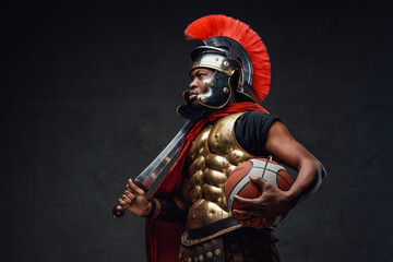 Naklejka premium Black sportsman with basketball in legionary costume
