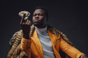 Successful black businessman holding brilliant